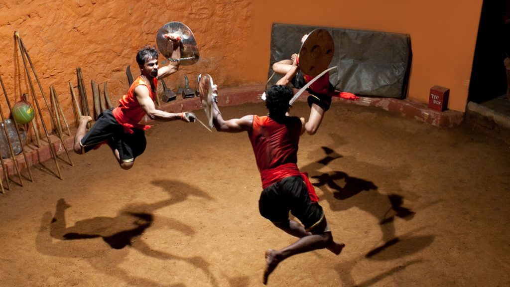 Indian men performing Kalaripayattu marital art in Kalaripayattu Center at Thekkady in the state of Kerala, India.