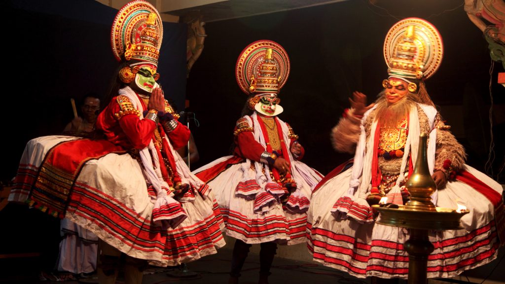 Kathakali artists perform on stage during a temple festival in Thiruvalla, Kerala, India.